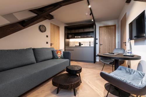 a living room with a couch and a table at Wailtl Hotel in Dorfen
