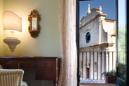 a room with a window with a view of a church at Palazzo Marziale in Sorrento