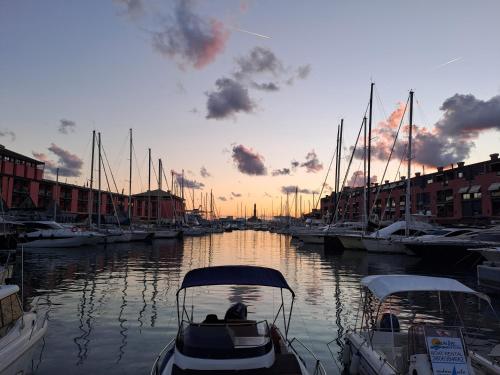 a boat is docked in a marina at sunset at La casa sul molo - Acquario in Genova