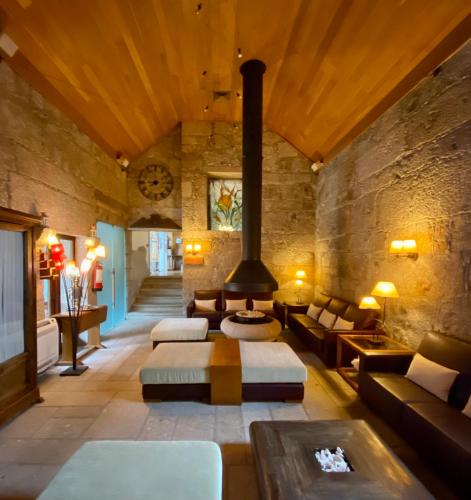 a living room with a fireplace in a building at Hotel de Charme Quinta do Pinheiro in Freamunde