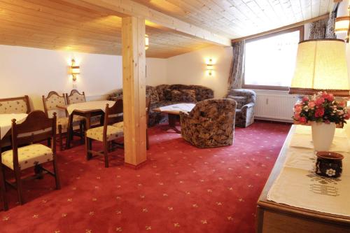 a living room with a table and chairs and a dining room at Haus Gariella in Gargellen