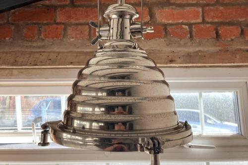 a silver cake sitting on top of a table at Stunning quirky 2-Bed Cottage in New Brighton in Wallasey