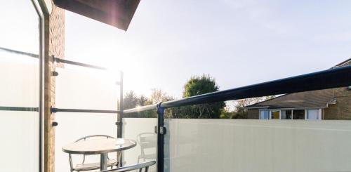 a balcony with a table and a railing at Roomspace Serviced Apartments - Cascades Court in London