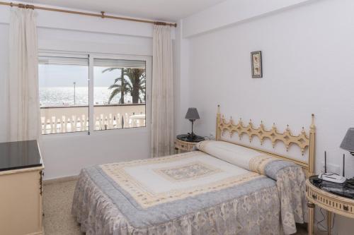 a bedroom with a bed and a view of the ocean at Lider, 2-G in Cullera
