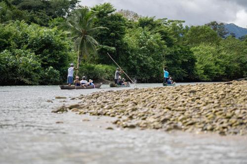 a group of people in boats on a river at Casa Balae in Nuquí