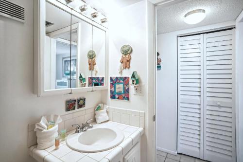 a bathroom with a sink and a mirror at Sunset Chateau 409 in St Pete Beach