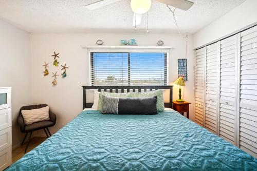 a bedroom with a bed and a window at Sunset Chateau 409 in St Pete Beach