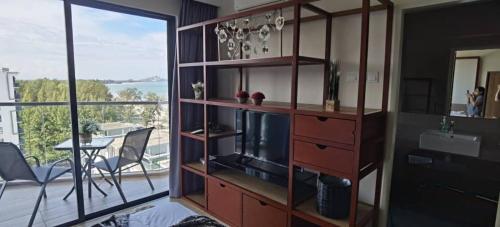 a living room with a entertainment center with a television at TimurBay Residence 2Bedroom with Seaview 6pax Level10 Kuantan in Kampong Tanjong