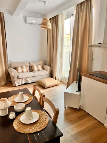 a living room with a table and chairs and a couch at ADI BOUTIQUE HOUSE in Thessaloniki