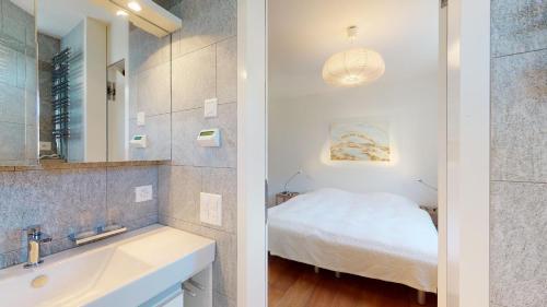 a bathroom with a sink and a bed in a room at Abitaziun Bellaval 1A - Celerina in Celerina
