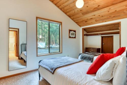 a bedroom with two beds and a mirror at Bitter Root Cabin - SM 10 in Black Butte Ranch