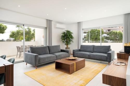 a living room with two couches and a table at Lagos luxury new 2 bedroom apartment built 2022 in Lagos