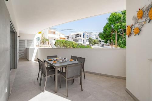 a dining room with a table and chairs on a balcony at Lagos luxury new 2 bedroom apartment built 2022 in Lagos