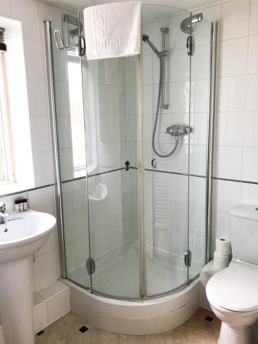 a bathroom with a shower and a toilet and a sink at Roomspace Serviced Apartments - The Courtyard in London