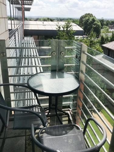 a table and chairs on a balcony with a view at Roomspace Serviced Apartments - The Courtyard in London