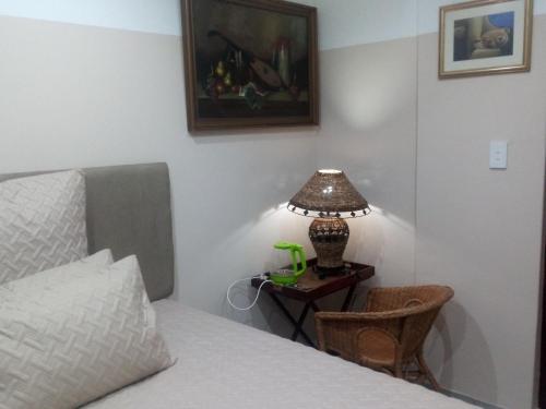 a bedroom with a bed and a table with a lamp at Dante Guest house in Alberton