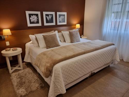 a bedroom with a large bed and a table at Saison Resort & Spa in Itaipava