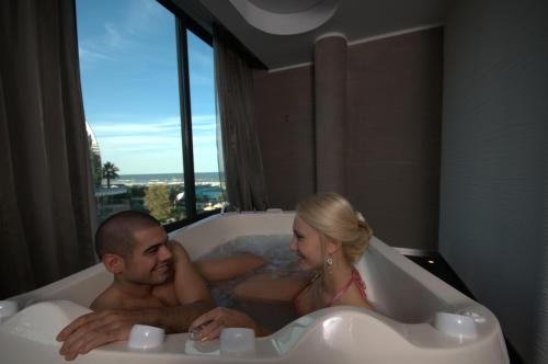 a man and a woman sitting in a bath tub at Hotel Le Palme - Premier Resort in Milano Marittima