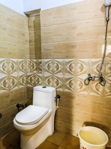 a bathroom with a toilet and wooden walls at Hotel Goverdhan - Walking to Raja Ki Mandi Railway and 3km from ISBT in Agra