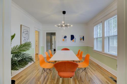 a dining room with a white table and orange chairs at Spacious 3BR Cooper-Young Bungalow - Sleeps 8 - Walkable to Dining - Easy Access to Downtown - Parking in Memphis