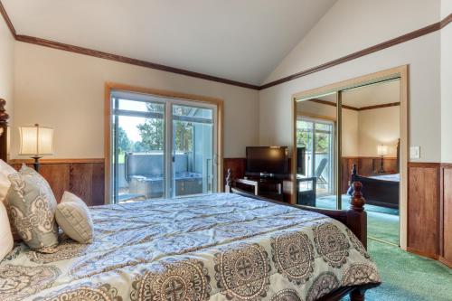 a bedroom with a bed and a large mirror at Tree Branch Cabin in Sunriver