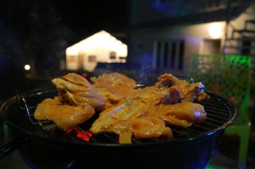 a bunch of food cooking on a grill at The Nirvana Resort Munnar in Munnar