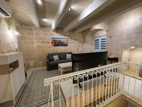a living room with a staircase leading to a living room at Valletta Home -Dar il-Kavallier Jacques de Quiqueran in Valletta