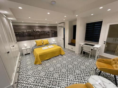 a bedroom with a bed with a yellow bedspread at Valletta Home -Dar il-Kavallier Jacques de Quiqueran in Valletta