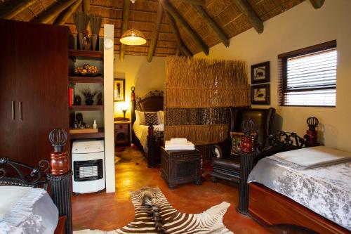 a room with two zebras laying on the floor at Indalu Game Reserve in Boggomsbaai