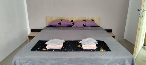 a bedroom with a bed with two towels on it at Cazare Isa in Deva