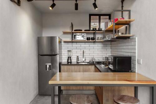 a kitchen with a wooden table and a refrigerator at +MS +Único loft +Inmejorable ubicación +Arcos loft 1 in Laborcillas