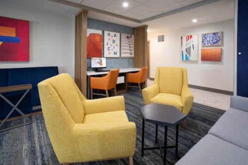 a waiting room with chairs and a table at Holiday Inn Express Hotel & Suites Grand Junction by IHG in Grand Junction