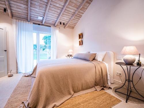 a bedroom with a bed and a large window at Casa do Gaiteiro 