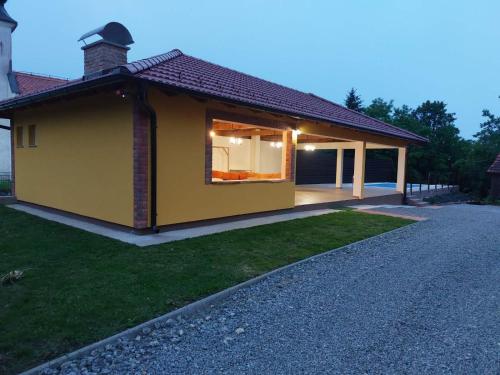 a small yellow house with a pitched roof at Relax&Wine house Klara in Ruškovac