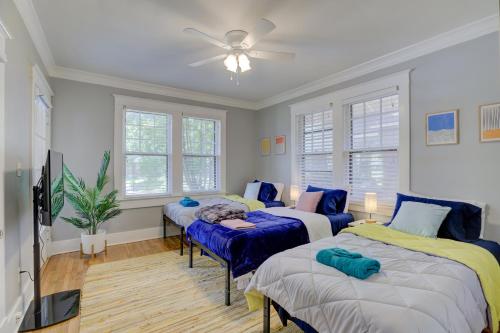 a room with three beds in it with a ceiling fan at Vintage Vibes in Walkable Midtown - Spacious Bungalow with 6 beds in Central Location in Memphis