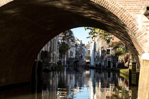 a bridge over a river in a city at Court Hotel City Centre Utrecht in Utrecht