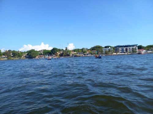 a large body of water with boats in it at CASA CONFORTÁVEL COM 4 QUARTOS EM ALTER DO CHÃO in Alter do Chao