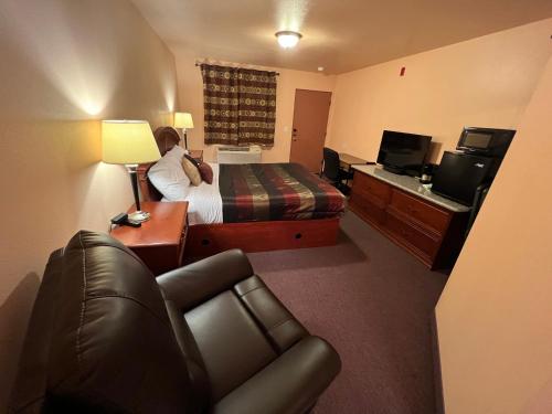 a hotel room with a bed and a couch at Frazier View Motel in Frazier Park