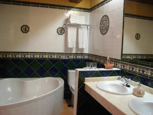 a bathroom with a tub and a toilet and a sink at Señorio De Altamira - Adults Only in Santillana del Mar