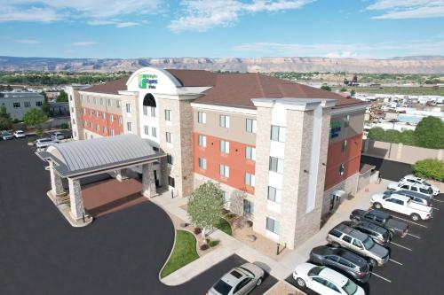 a rendering of a hotel with cars parked in a parking lot at Holiday Inn Express Hotel & Suites Grand Junction by IHG in Grand Junction