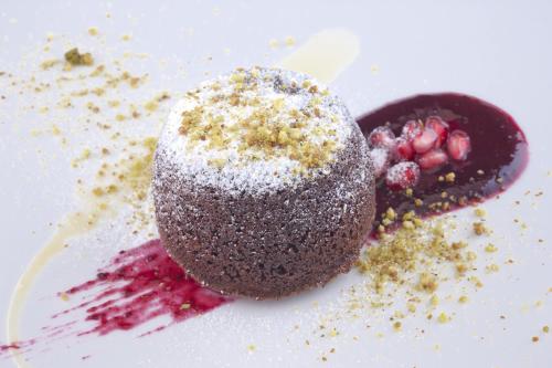 a chocolate dessert with powdered sugar on a white plate at Hotel Forza Mare in Kotor