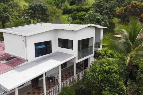 an aerial view of a white house with trees at FINCA EL PROGRESO cabañas tipo apartamento in Anapoima