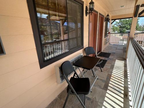 a porch with two chairs and a window at Frazier View Motel in Frazier Park