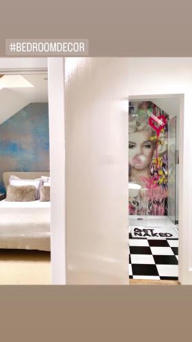 a bedroom with a poster of a woman on the wall at Mrs Butlers Stylish Mews House Central Brighton Great Prices in Brighton & Hove