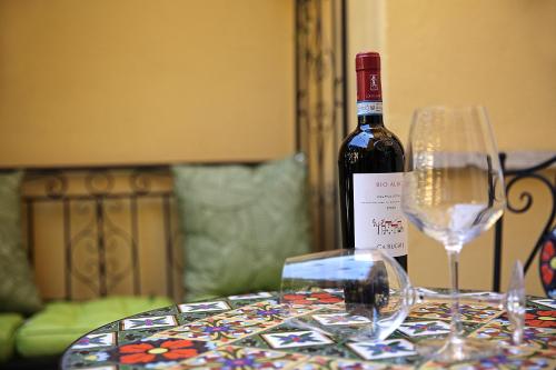 a bottle of wine sitting on a table with two glasses at Romantic Verona in Verona