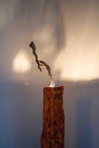 a vase with a branch sticking out of it at Atelier Inès Arts & Suites in Naples