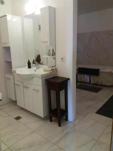 a bathroom with a sink and a table in it at Reykjavik Apartment Garden and Terrace in Reykjavík