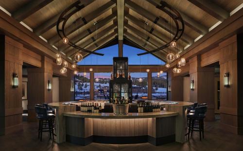 a bar in a restaurant with a large window at Montage Big Sky in Big Sky