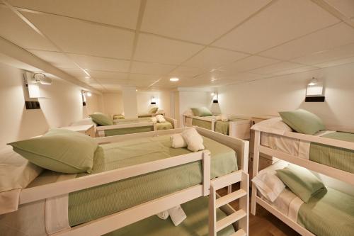 a room with four bunk beds in it at ALBERGUE SEGUE O CAMIÑO in Sigüeiro