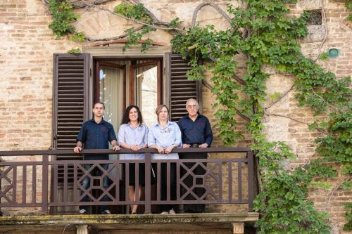 a group of people standing on a balcony at Hotel La Cisterna in San Gimignano
